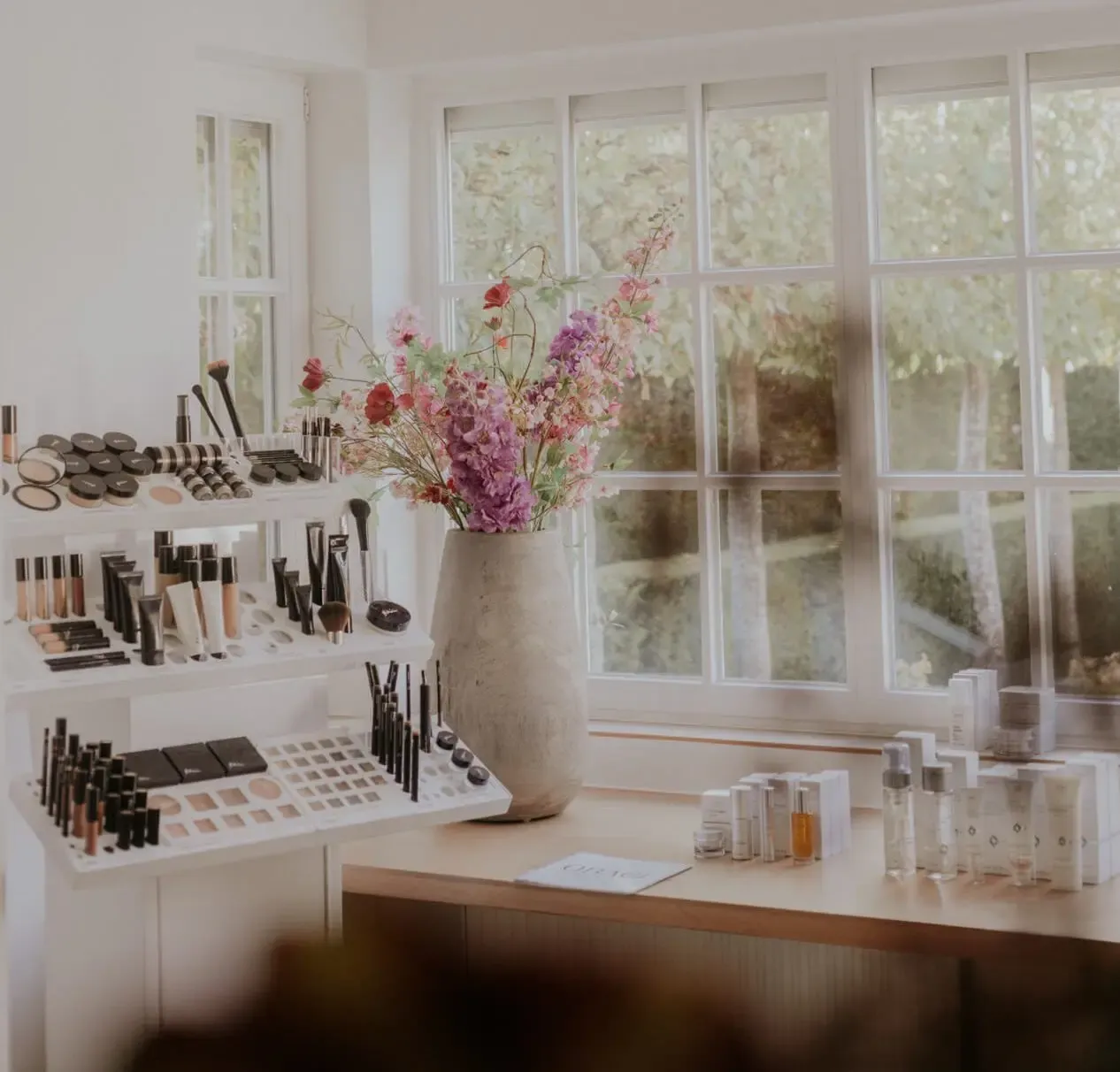 Makeup display with cosmetics and flowers